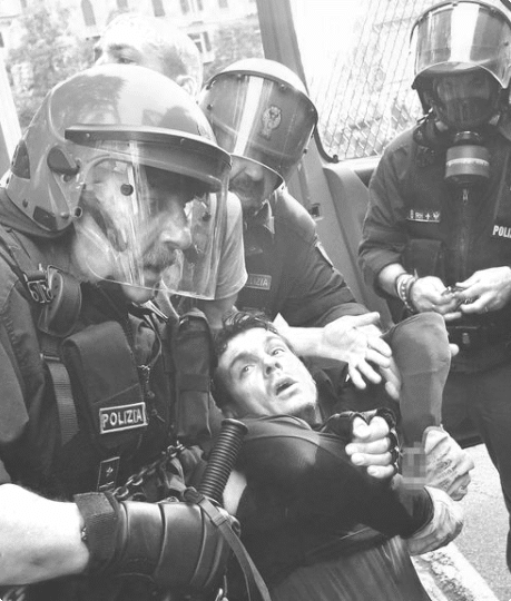 man being held down by police