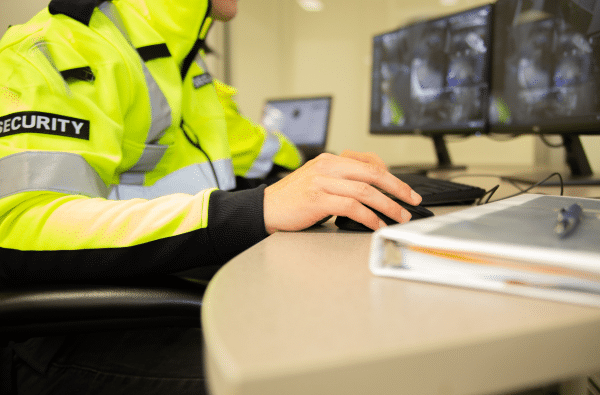 close-up of a security officer seated in a surveillance room