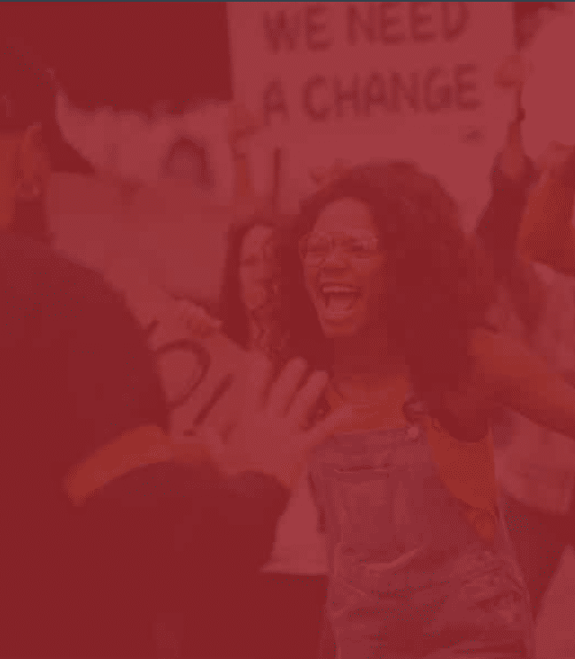 protesting people holding signs that read "WE NEED A CHANGE"